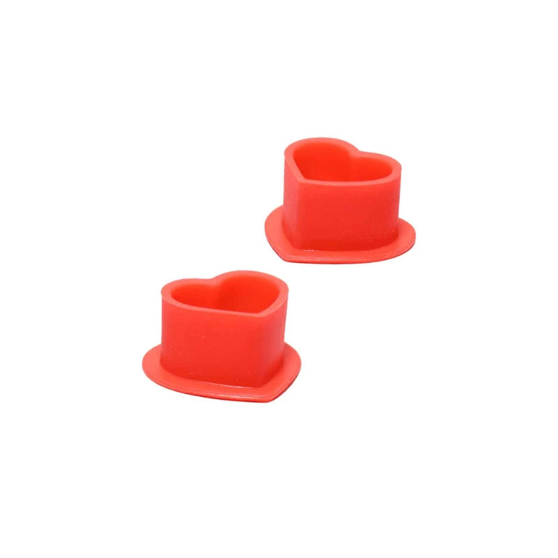 Two red heart-shaped tattoo silicone cups on a white background